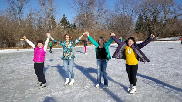 Group of people ice skating.