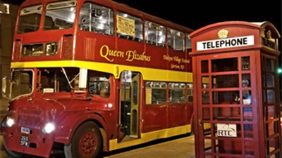 Bus with a phone booth in view.